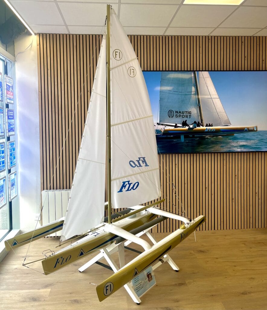 Dans nos bureaux, une pièce unique attire immédiatement l’attention : la maquette du trimaran FLO. Cette reproduction fidèle rend hommage à un bateau mythique de la course au large, entré dans l’histoire grâce à Florence Arthaud, victorieuse de la Route du Rhum en 1990.